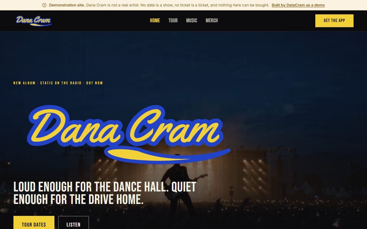 The Dana Cram demo site: a disclosure bar, a yellow-and-blue script wordmark over a festival stage at dusk, and a tour-date ticker.