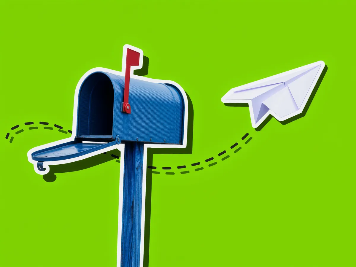 A metal mailbox with its red flag raised next to a paper airplane on a green background.