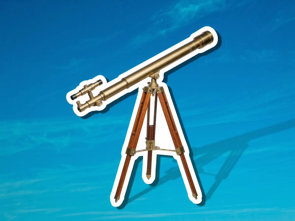 A brass telescope on a wooden tripod against a blue duotone background.