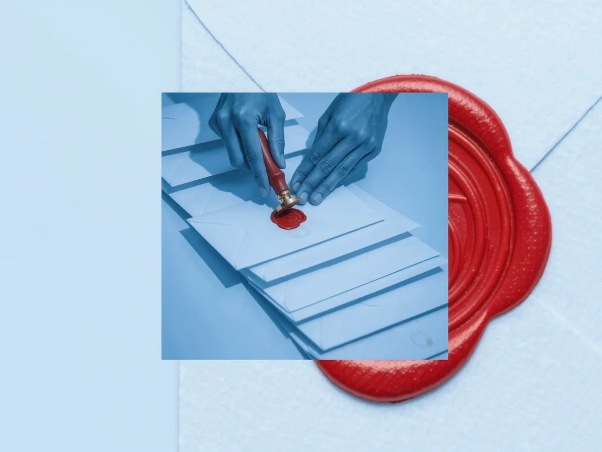 Hands pressing a red wax seal onto one envelope in a row of identical envelopes.