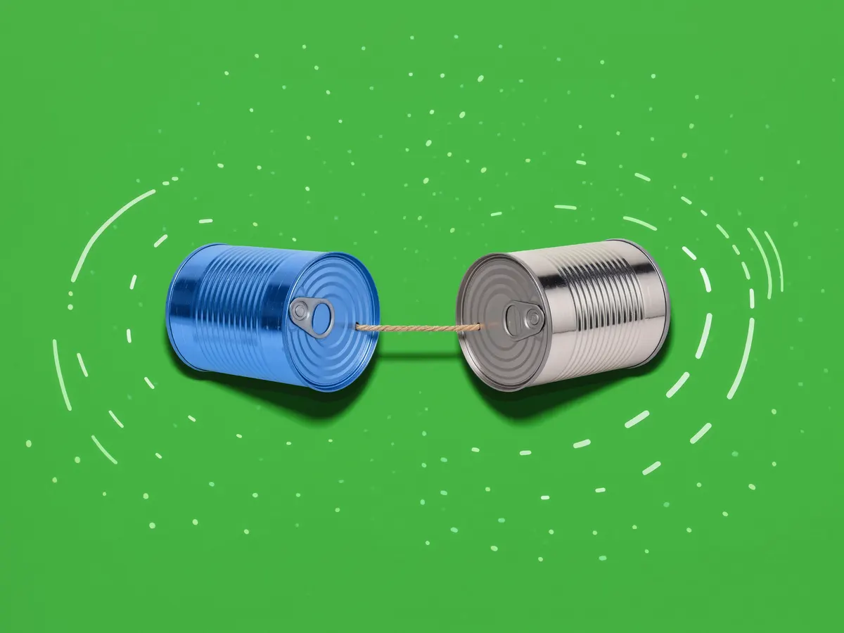 Two tin-can telephones connected by a taut string on a green background.